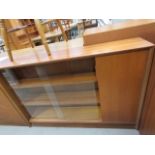 Teak bookcase with glazed sliding doors and cupboard to side Condition fair