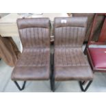 Pair of brown leather effect dining chairs Scratch to back of leather on one chair