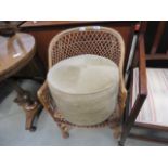 Cane armchair plus fabric footstool Wicker binding broken in places, overall condition is fair