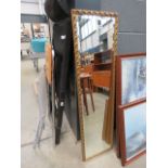 Narrow rectangular bevelled mirror in gilt frame