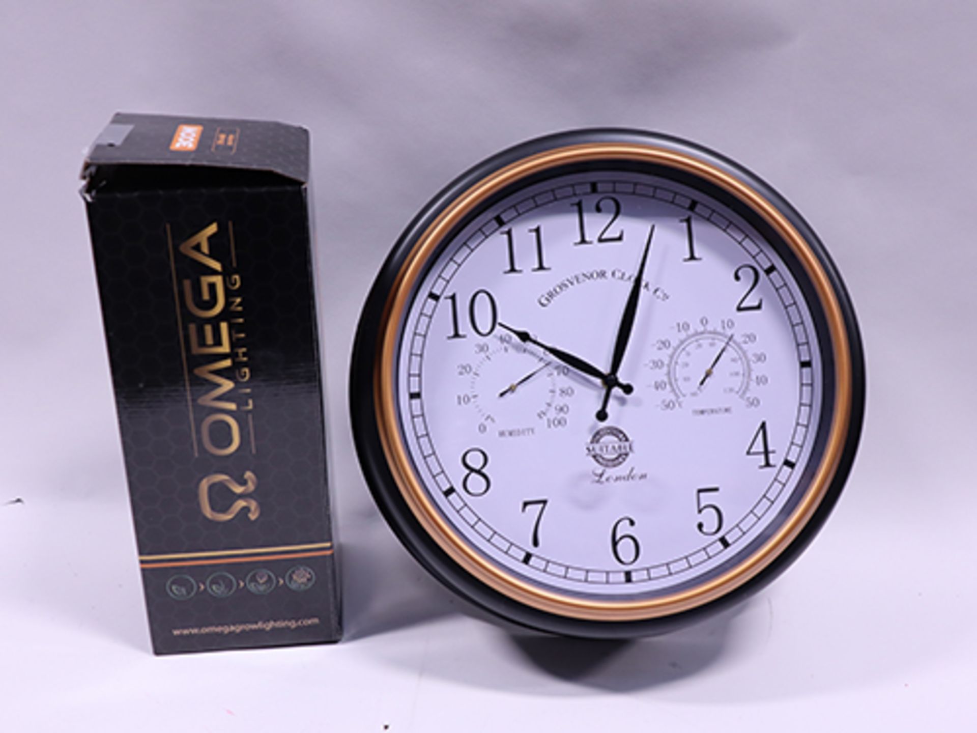 Omega grow lamp and a Grosvenor Clock Co. indoor/outdoor clock