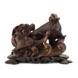 A 20th century Chinese hardstone figure modelled as a dragon chasing the moon, w.