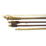 A pair of curtain poles with brass stylised acorn finials, approx.