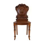 A Victorian mahogany armorial side chair with a solid seat and turned front legs