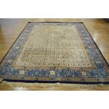 A 20th century Indian woollen rug with a blue border,