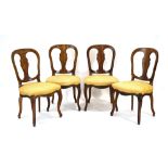 A set of four Victorian bow-backed walnut and marquetry dining chairs on cabriole legs