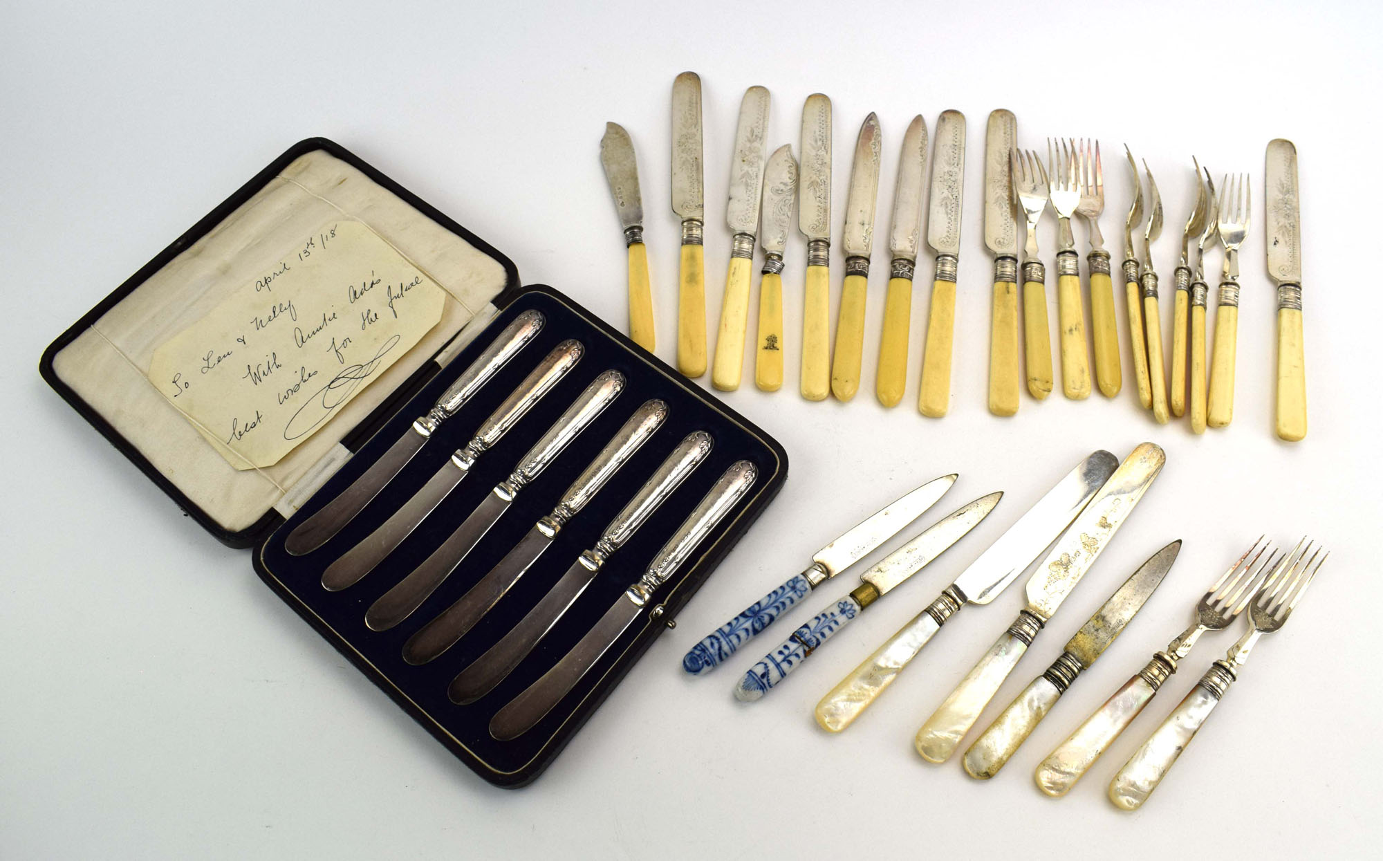 A cased set of six early 20th century silver handled butter knives, maker GHB, Sheffield 1916,