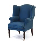 An early 19th century wingback armchair,