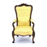 A 19th century rosewood and button upholstered armchair with scrolled arms and legs