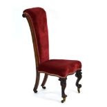 A 19th century rosewood and upholstered prie dieu prayer chair with carved front legs