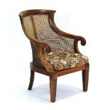 A 19th century mahogany and bergère armchair on square tapering supports CONDITION