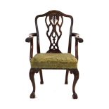 A mid-18th century mahogany elbow chair with a decorative pierce work splat,
