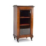 A Victorian walnut bookcase/cabinet, the brass gallery over a single glazed door,