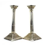 A pair of silver candlesticks of traditional Corinthian column form, maker AS, Birmingham 1961, h.