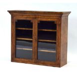A late 19th century walnut and strung glazed two-door cabinet with brass mounts,