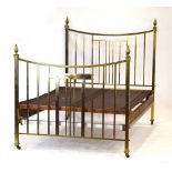 A late 19th/early 20th century brass-finished bedframe decorated with copper sections and