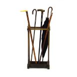 A late 19th/early 20th century brass stick stand containing four various silver-mounted walking