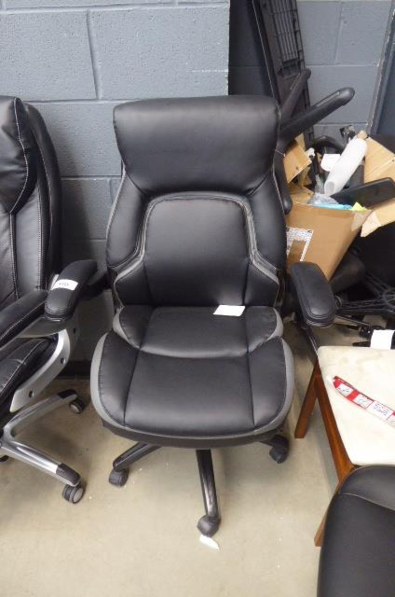 Black and grey high back executive armchair No rips or tears. Height adjustment works.