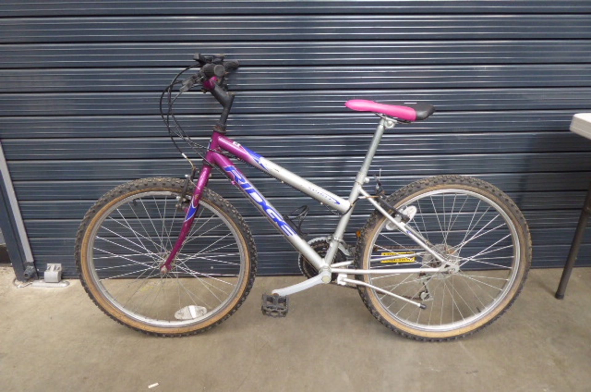 Silver, blue and purple ladies mountain bike Height: 24inch. Frame size 24 inches.