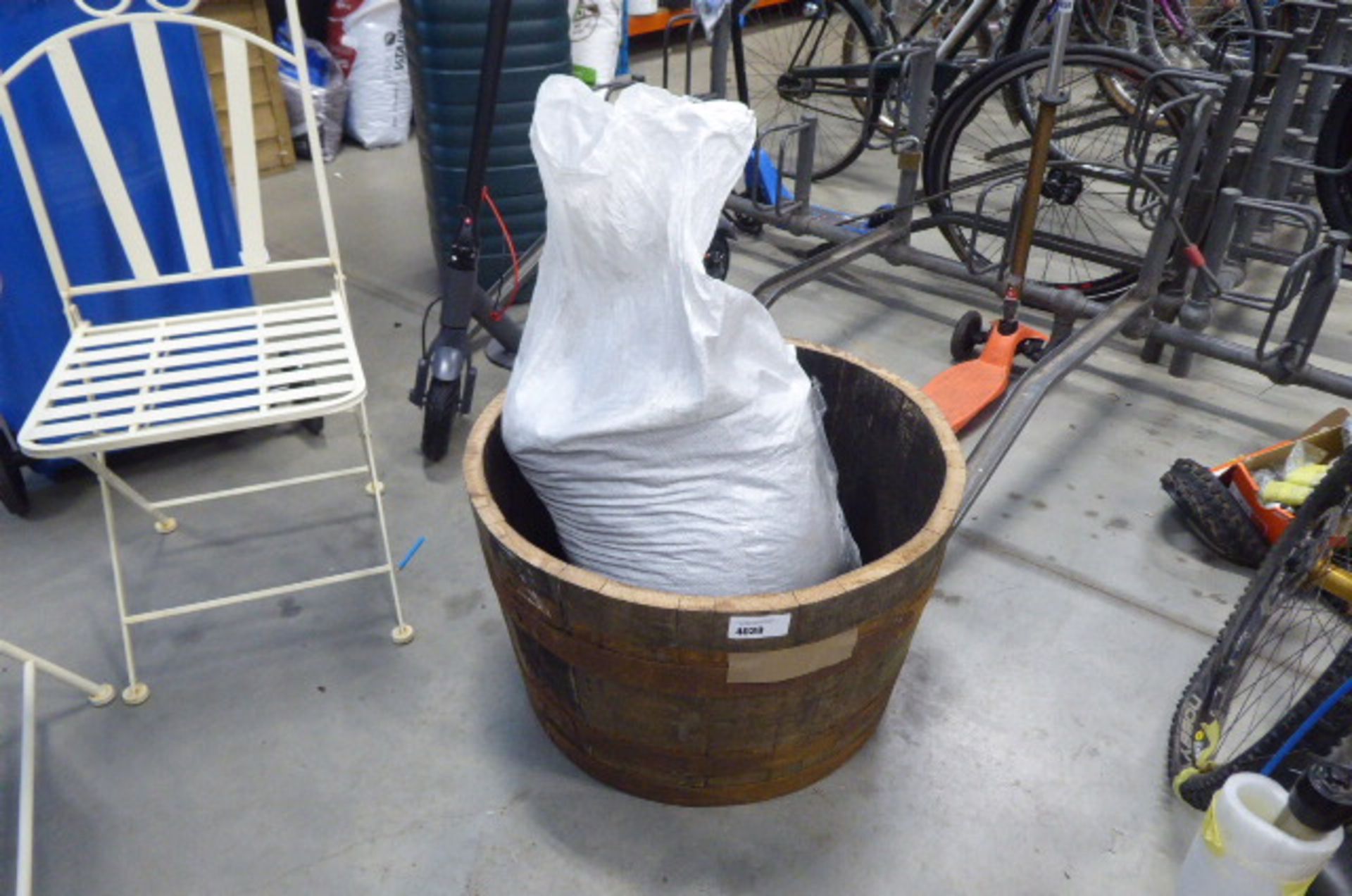 Half barrel planter and a bag of rubberised/chopped up tyres