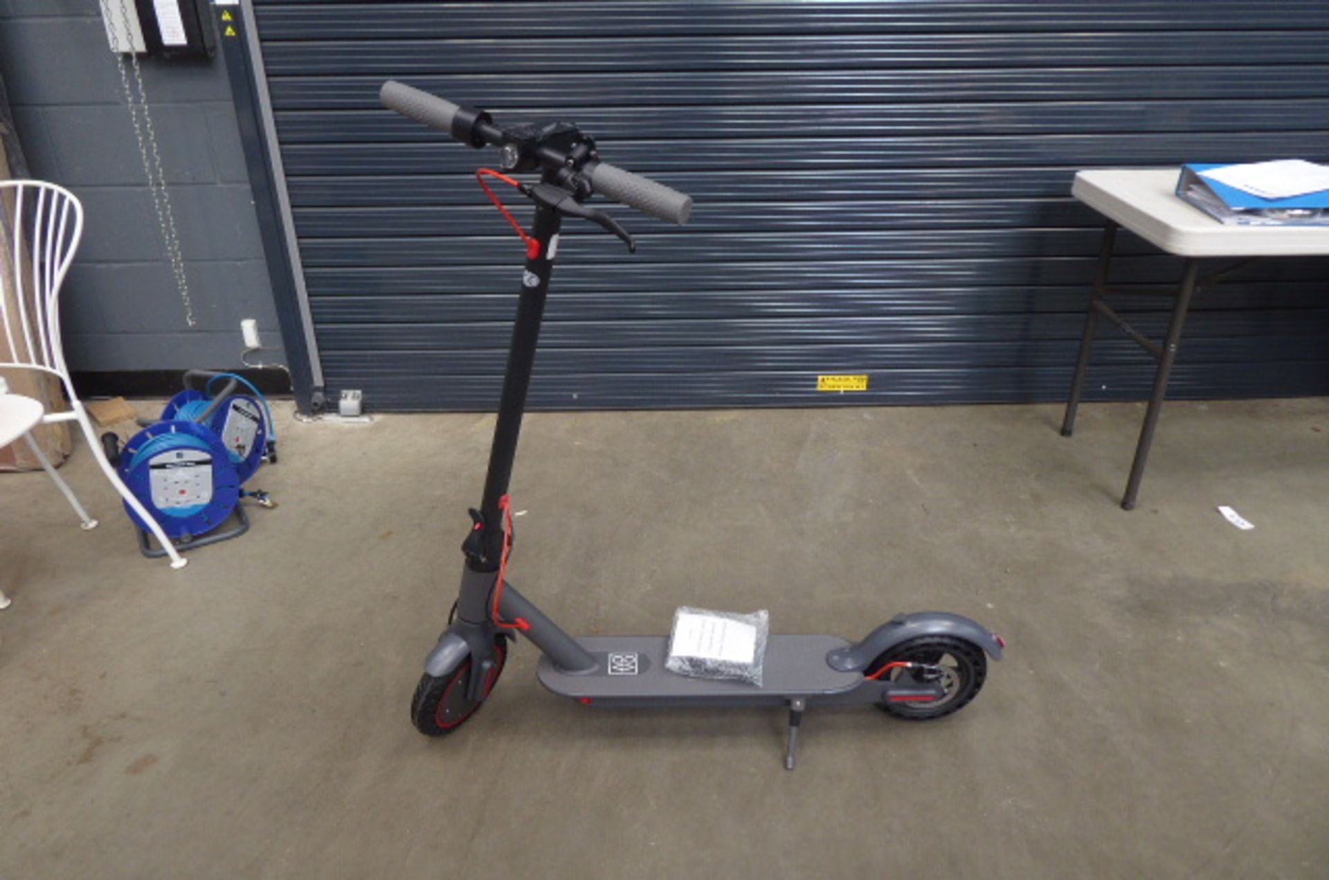 Grey electric scooter with charger