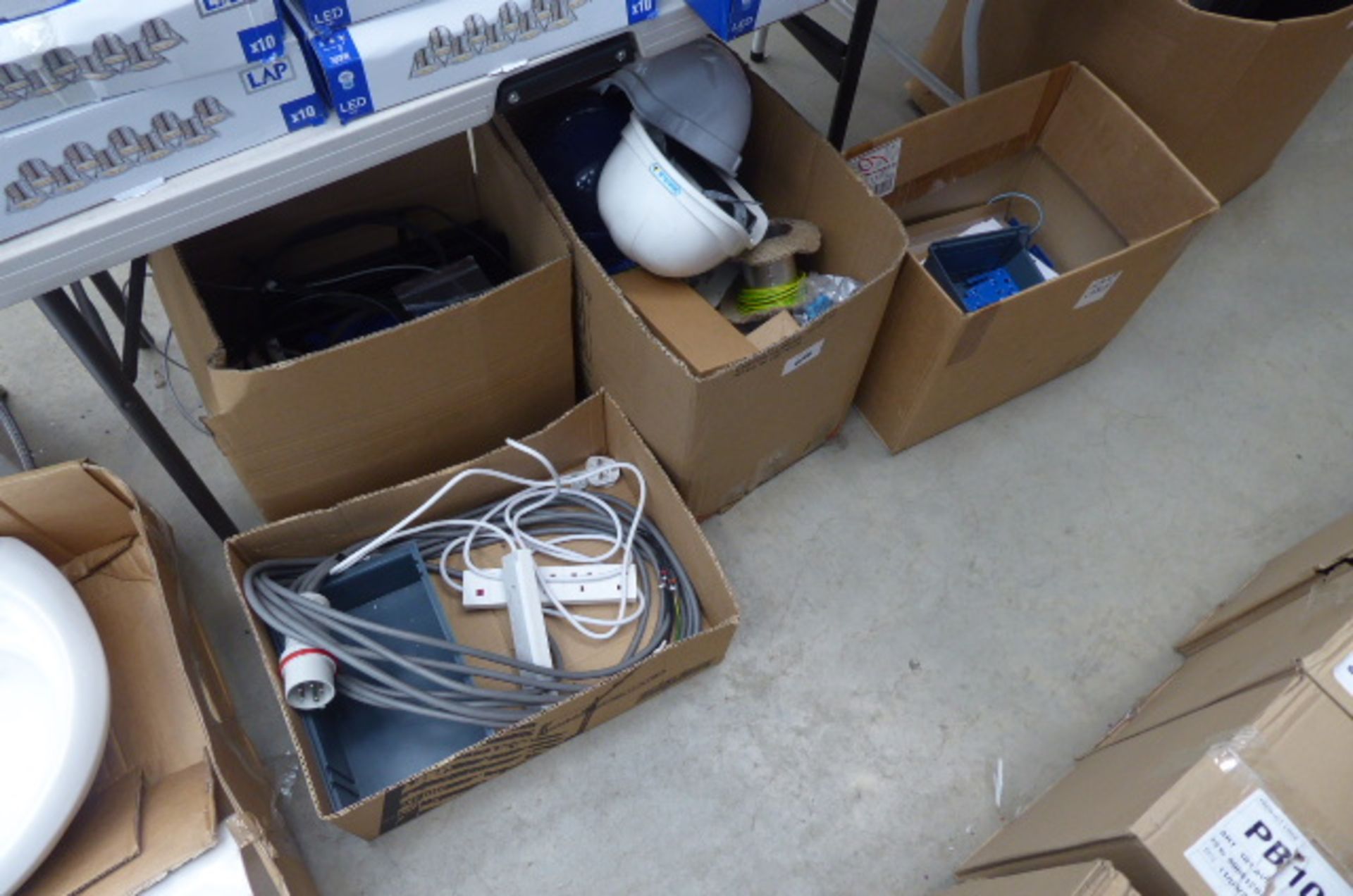 4 boxes containing hard hats, cable, extension cables, switches, etc