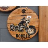Circular wooden sign with Suzuki motorbike motif