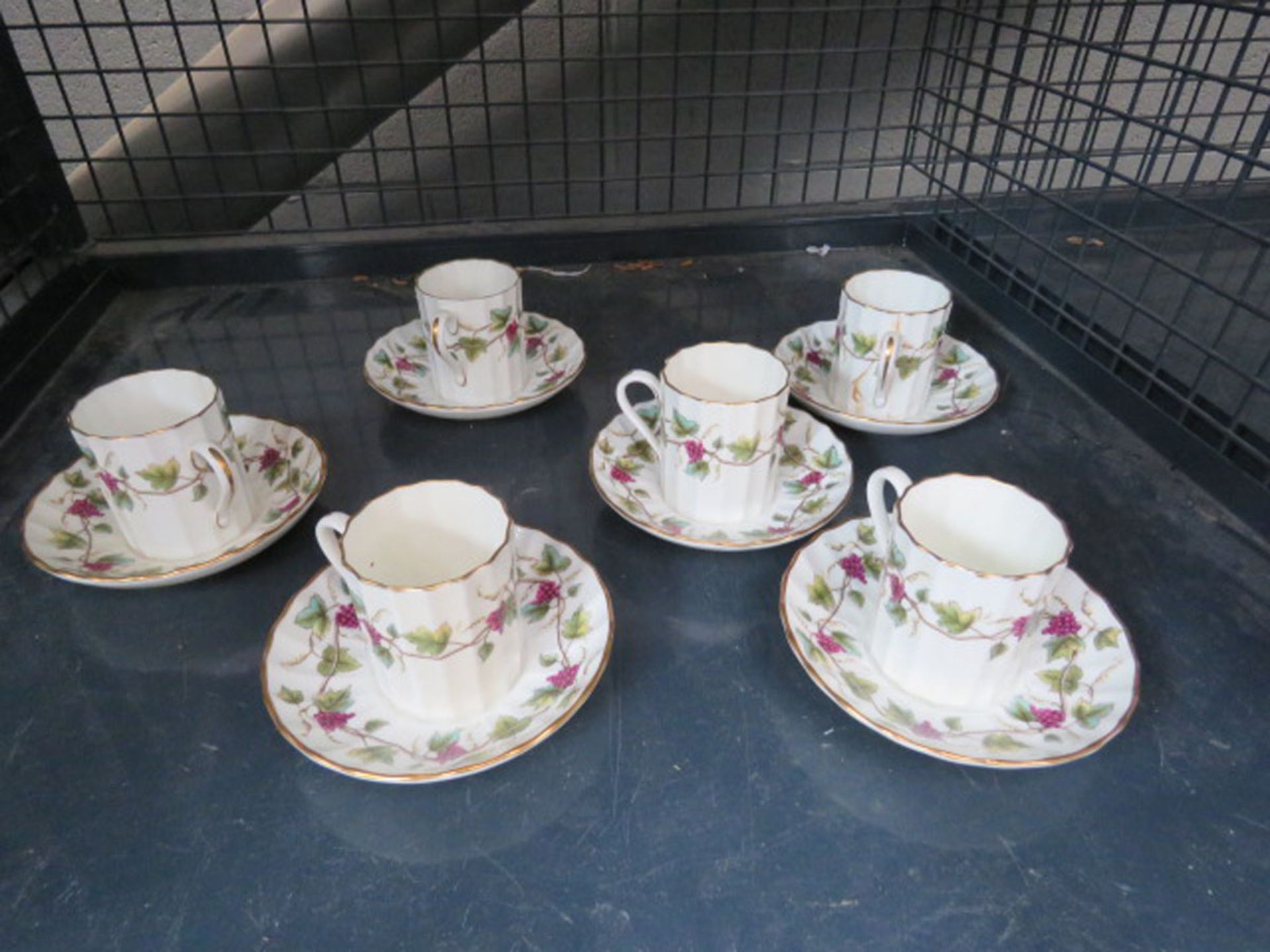 Cage containing 6 Royal Worcester Bacchanal coffee cups & saucers