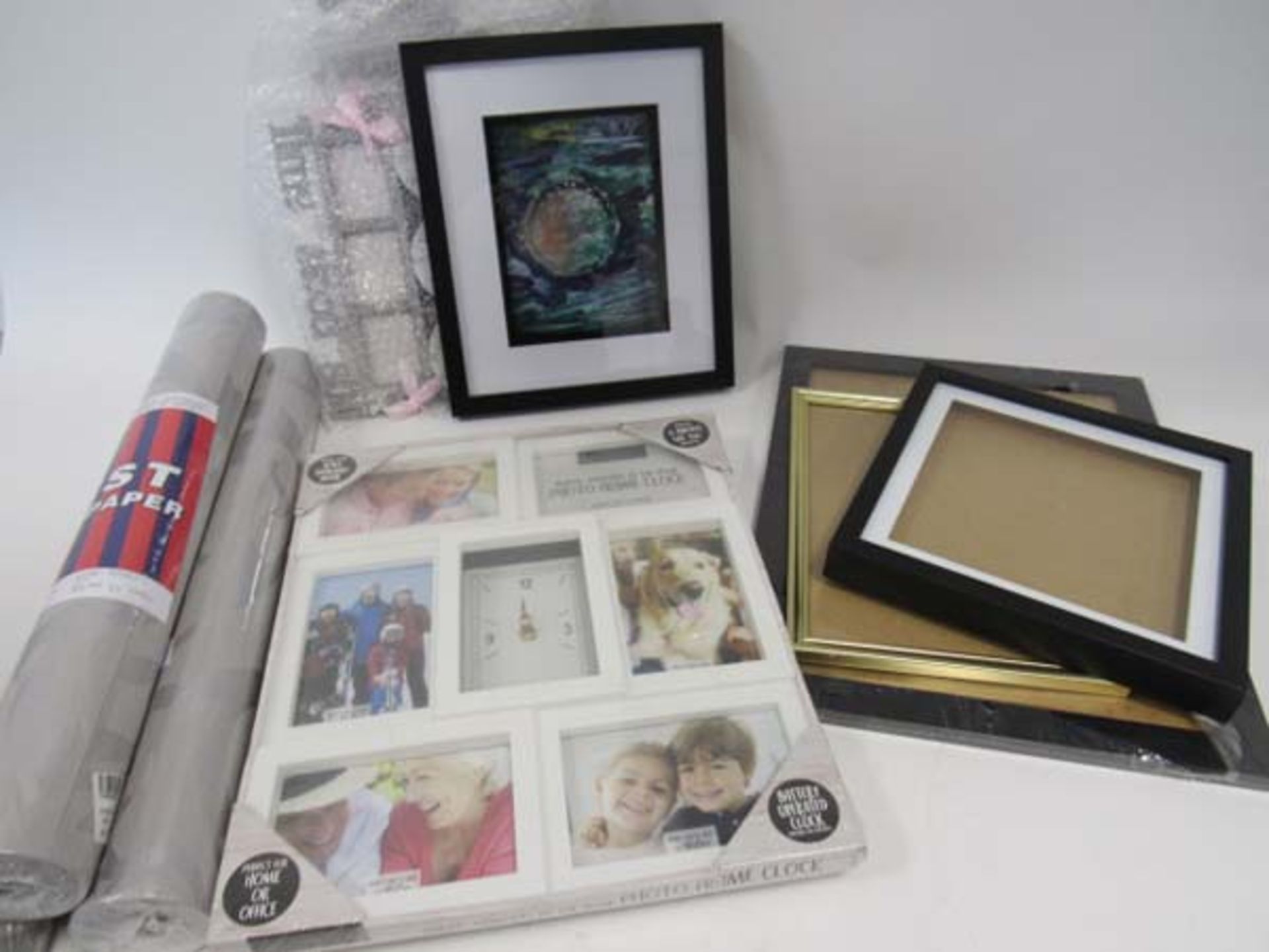 Quantity of various size frames, picture frame wall clock, and 3 rolls of grey patterned wallpaper