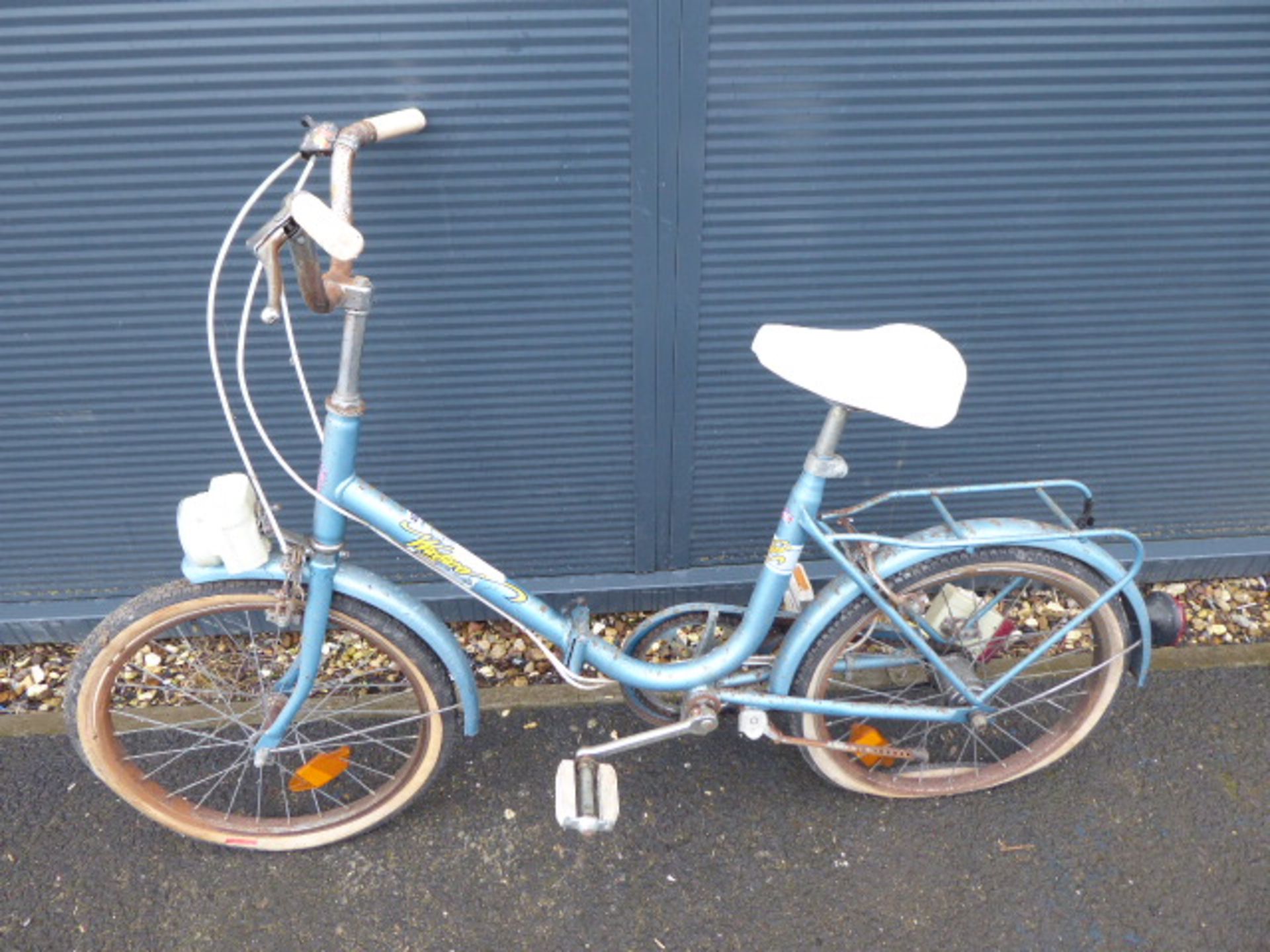 Blue vintage ladies fold up bike and a pink vintage shopper