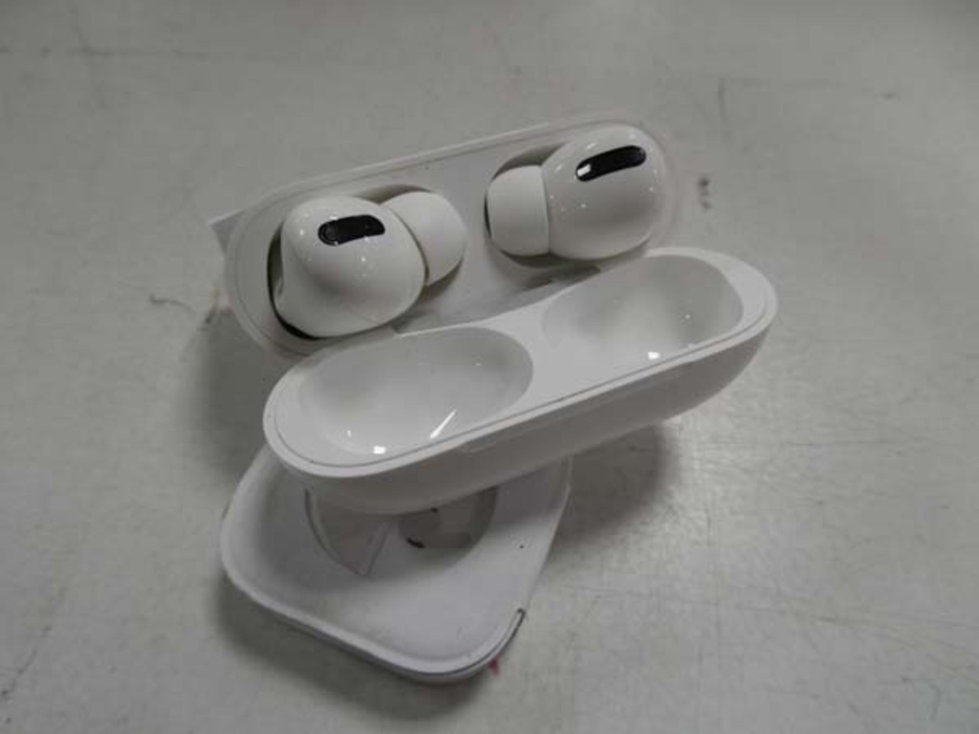 Apple AirPods Pro with spare eartips and wireless charging case