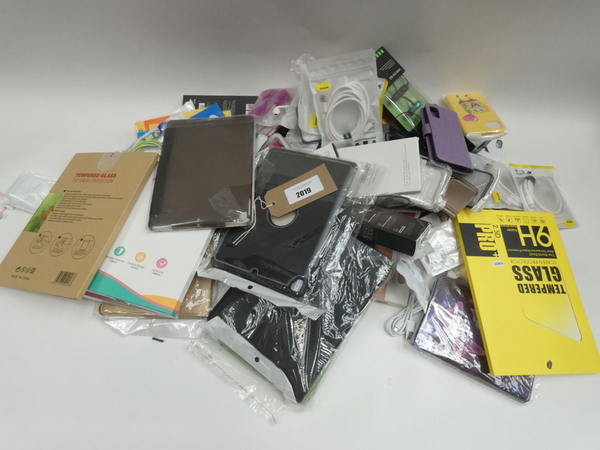 Bag containing various mobile phone accessories; cases, covers, cables, earphones, stands etc