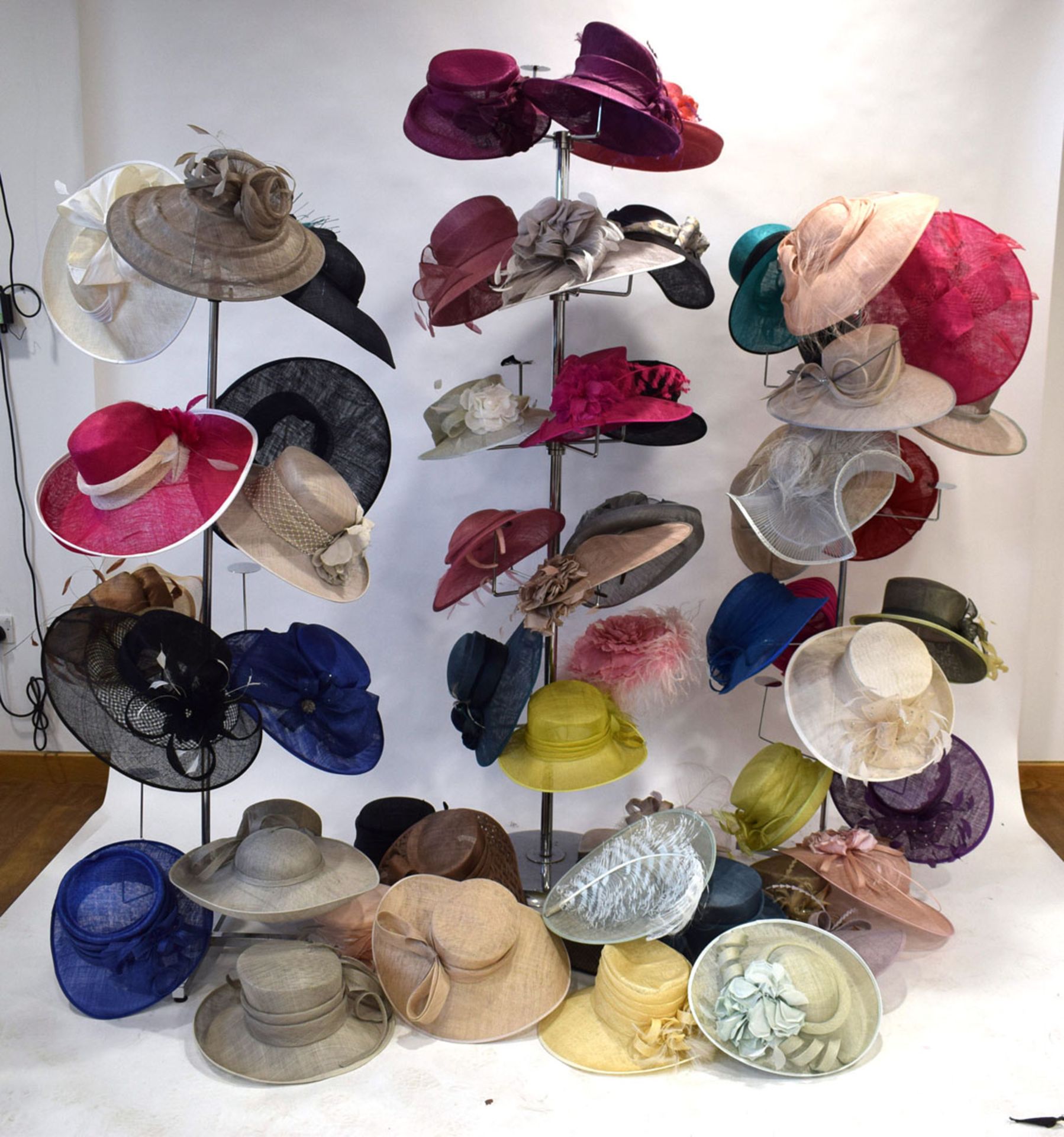 Approx. 55 occasion hats in various designs and colours (not including hat stands)