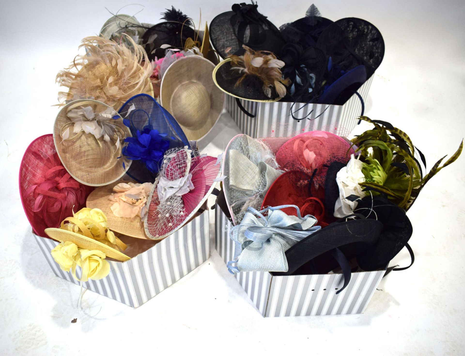 4 boxes of various saucer hats and fascinators in various colours and designs