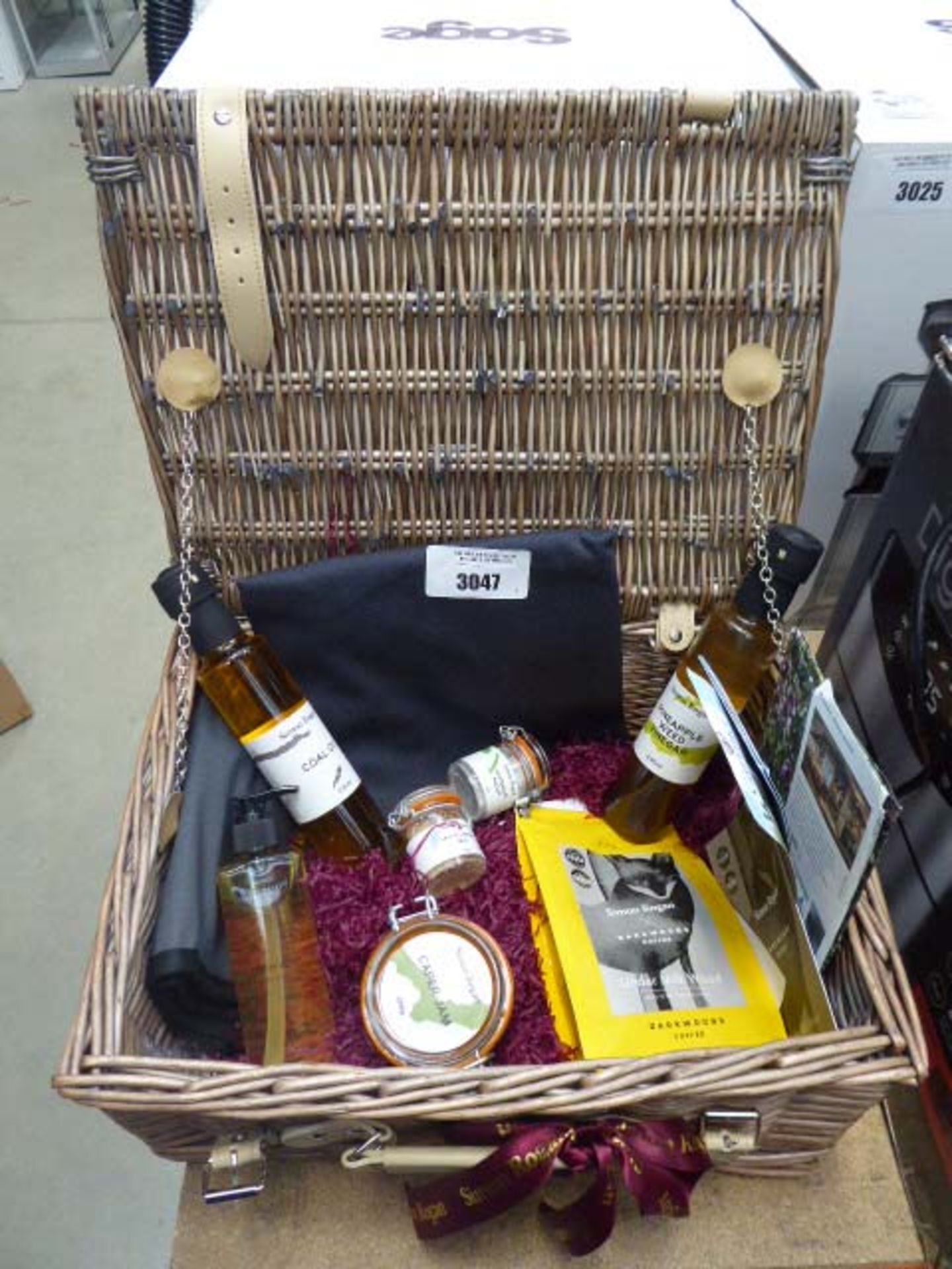 Hamper basket containing a bag of Darkwoods coffee, Caper jam, salt and vinegar, pineapple weed