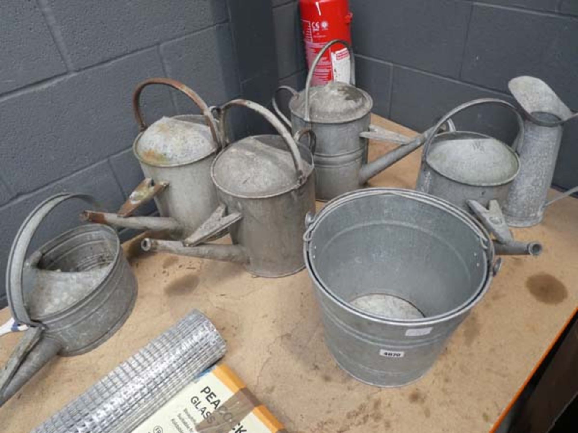 5 galvanised watering cans, 2 buckets and a galvanised jug