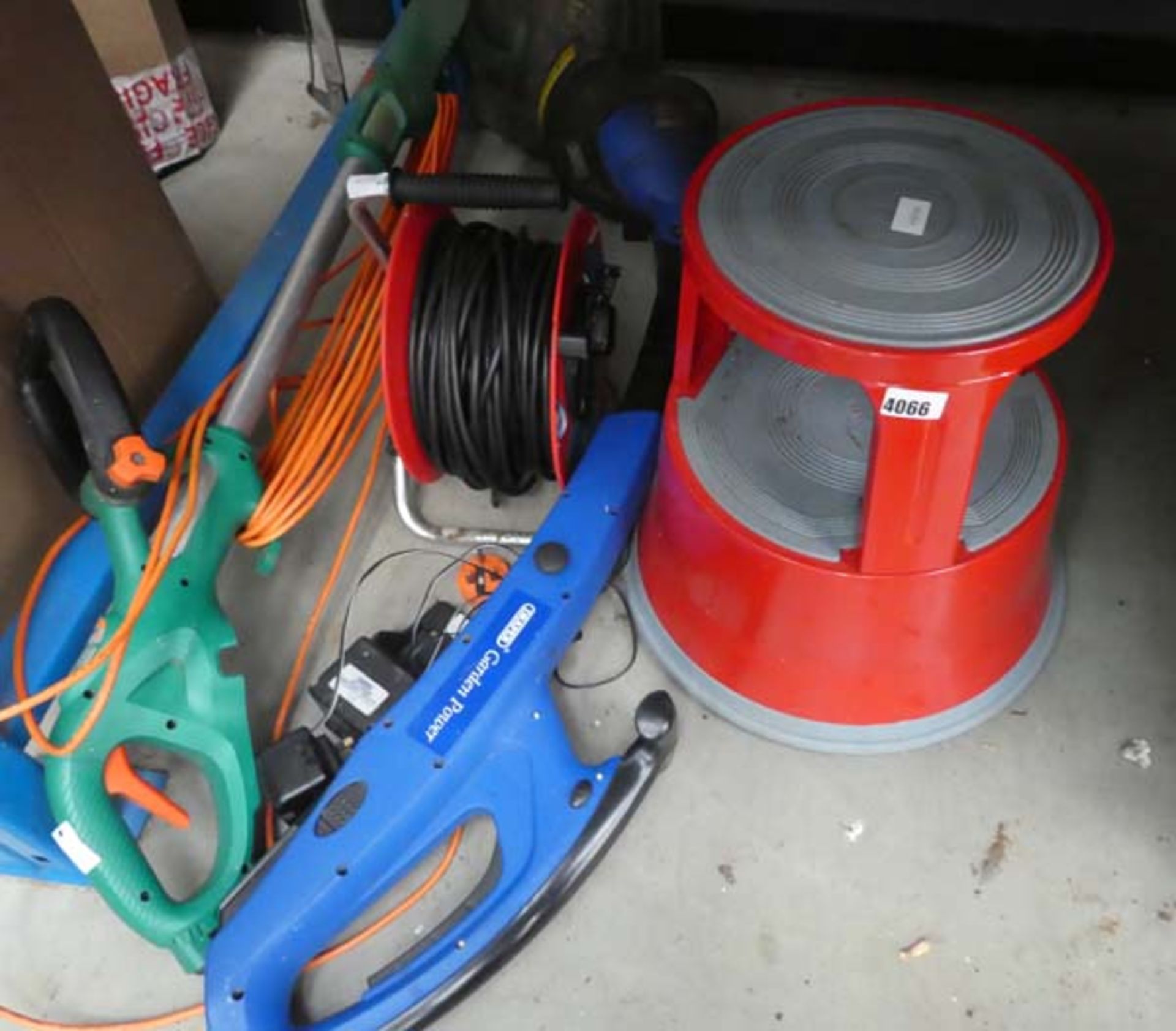 Half an underbay containing extension cable, 2 strimmers and an elephant step up stool