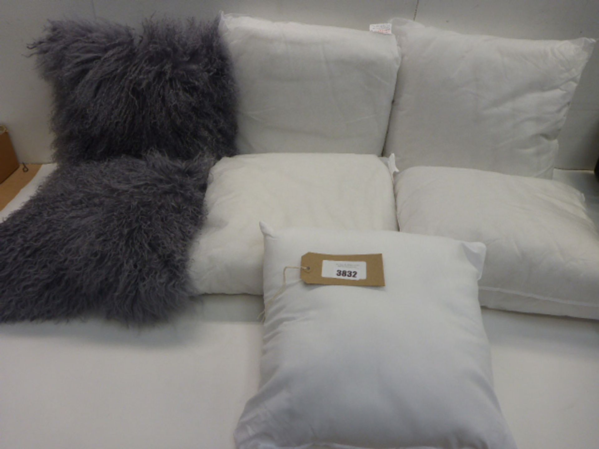 2 fluffy grey cushions and 5 inner cushion pads