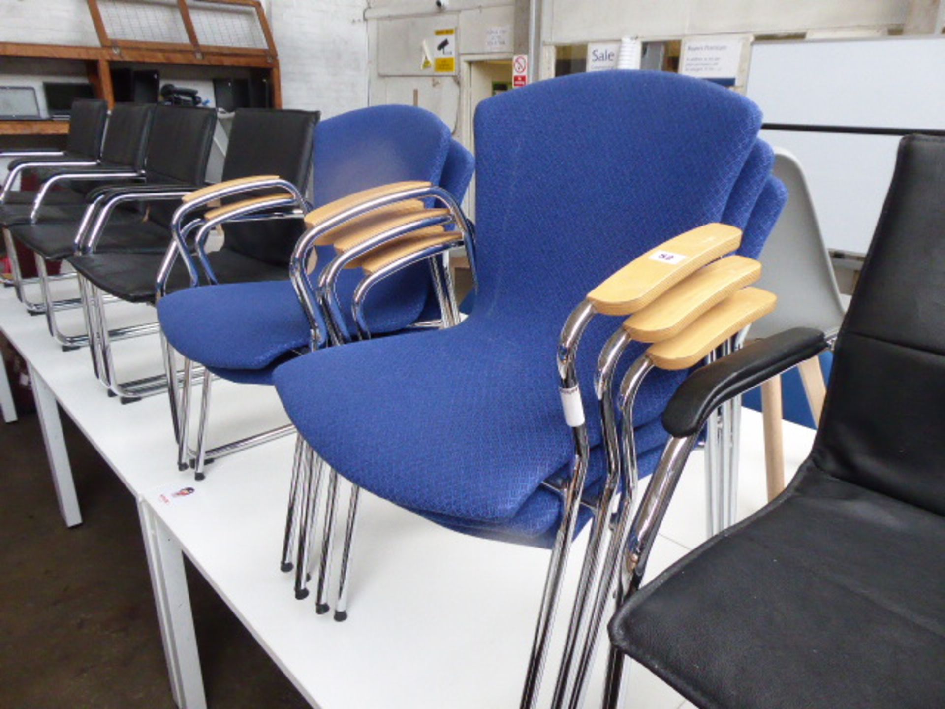 Five chrome frame blue cloth stacking chairs