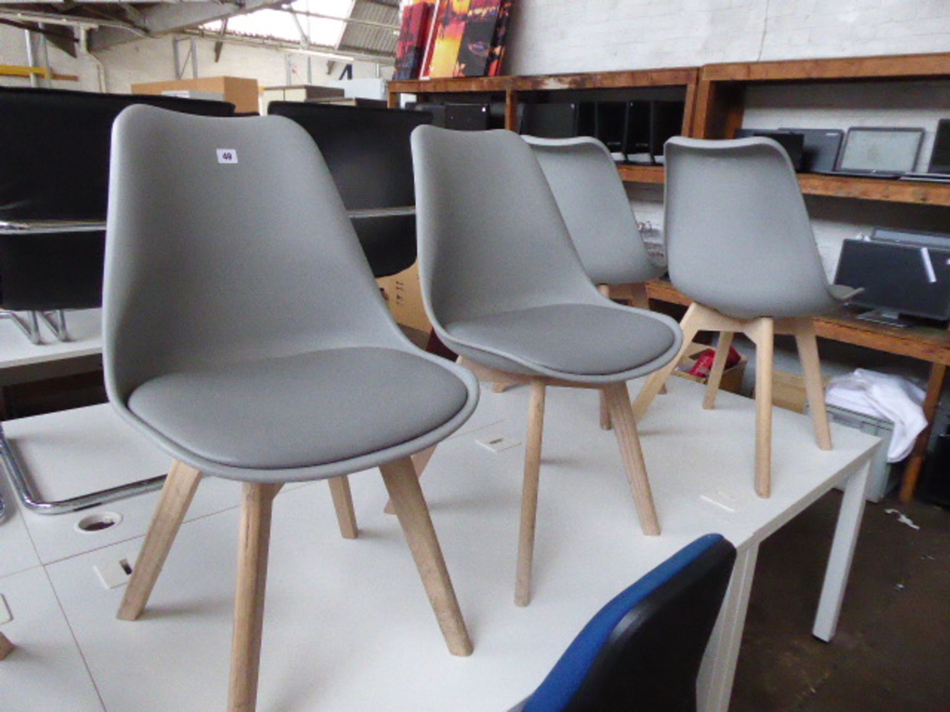 Six Habitat chairs with natural wooden finished legs and grey seat and seat pad