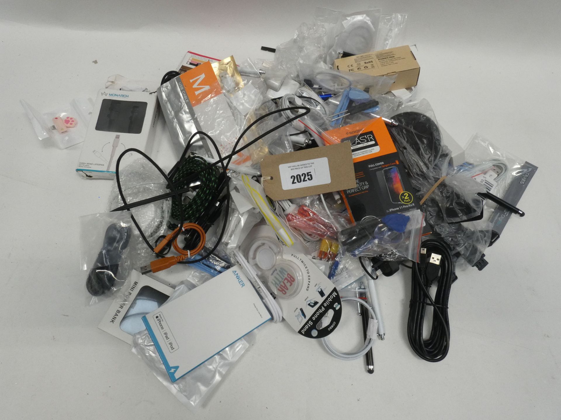 Bag containing quantity of various mobile phone accessories; cables, chargers, earphones, holders,