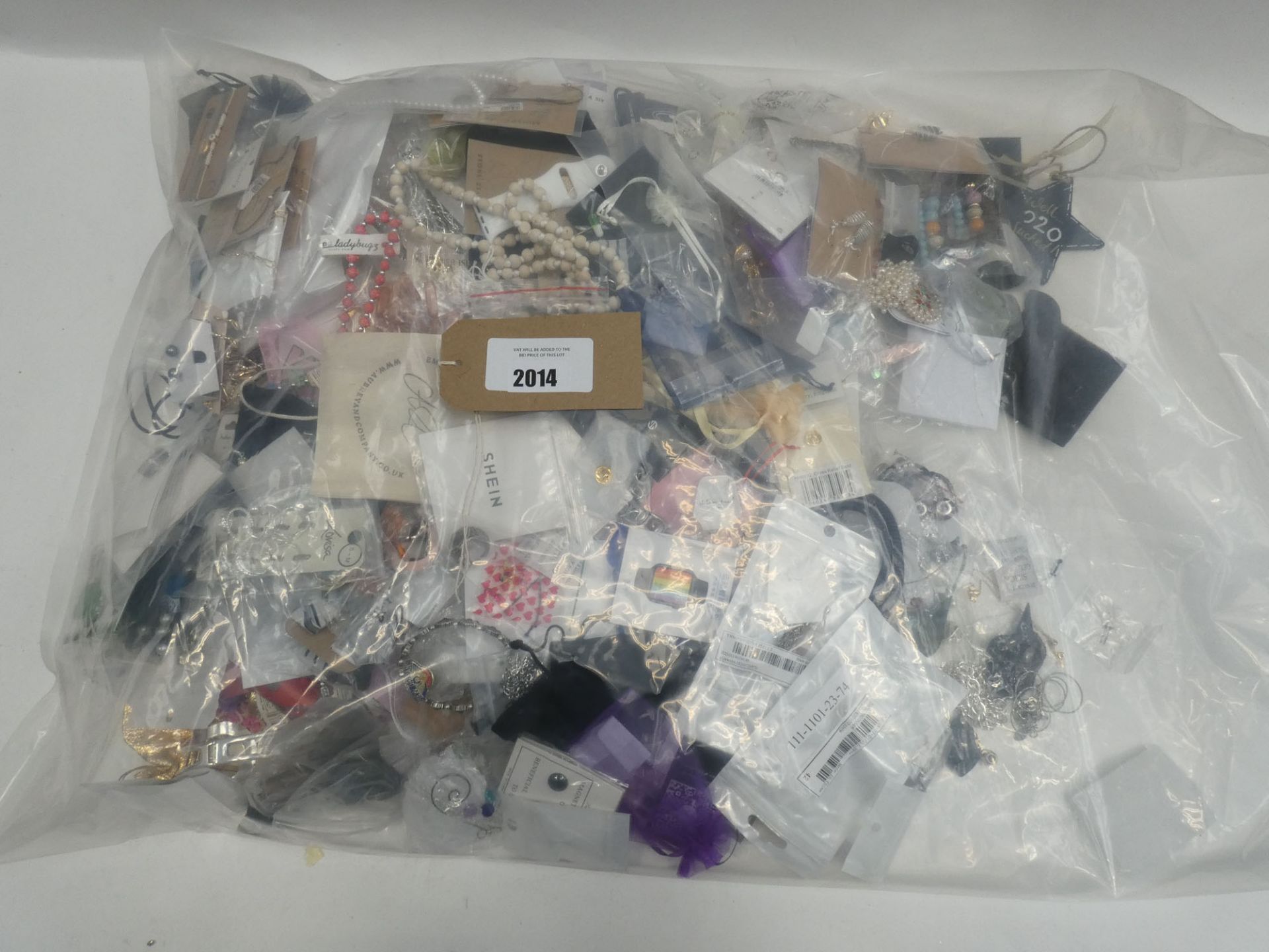 Bag containing quantity of loose costume and dress jewellery