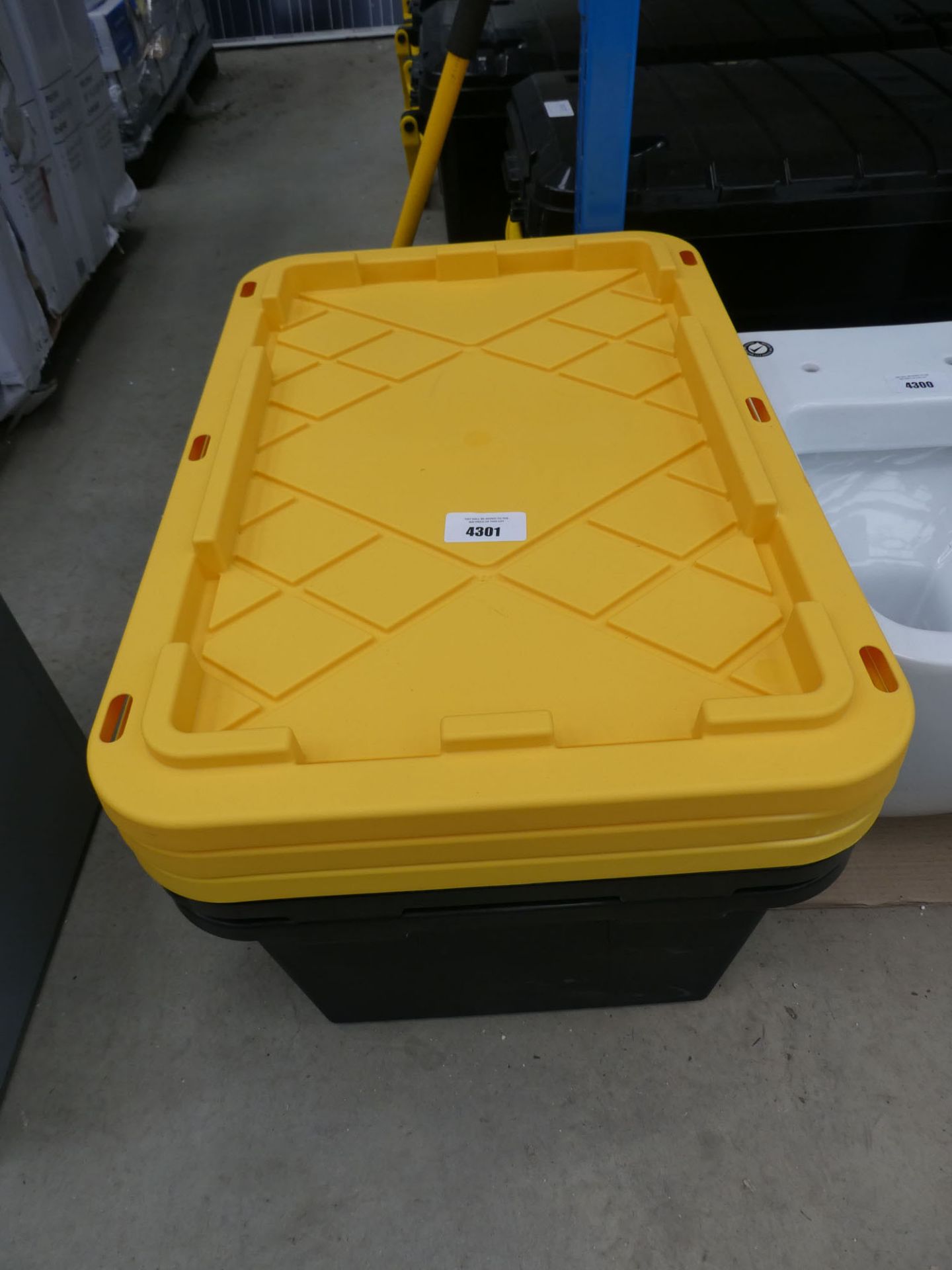 2 black storage boxes and 3 yellow lids