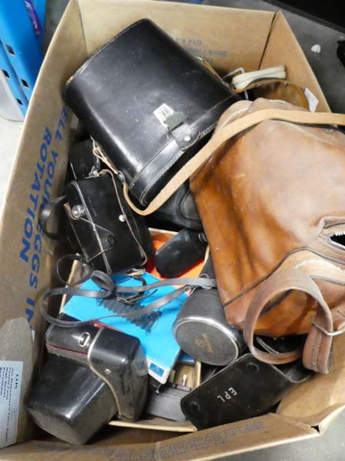 Bag containing a quantity of various optical equipment, cameras, lenses, binoculars, etc
