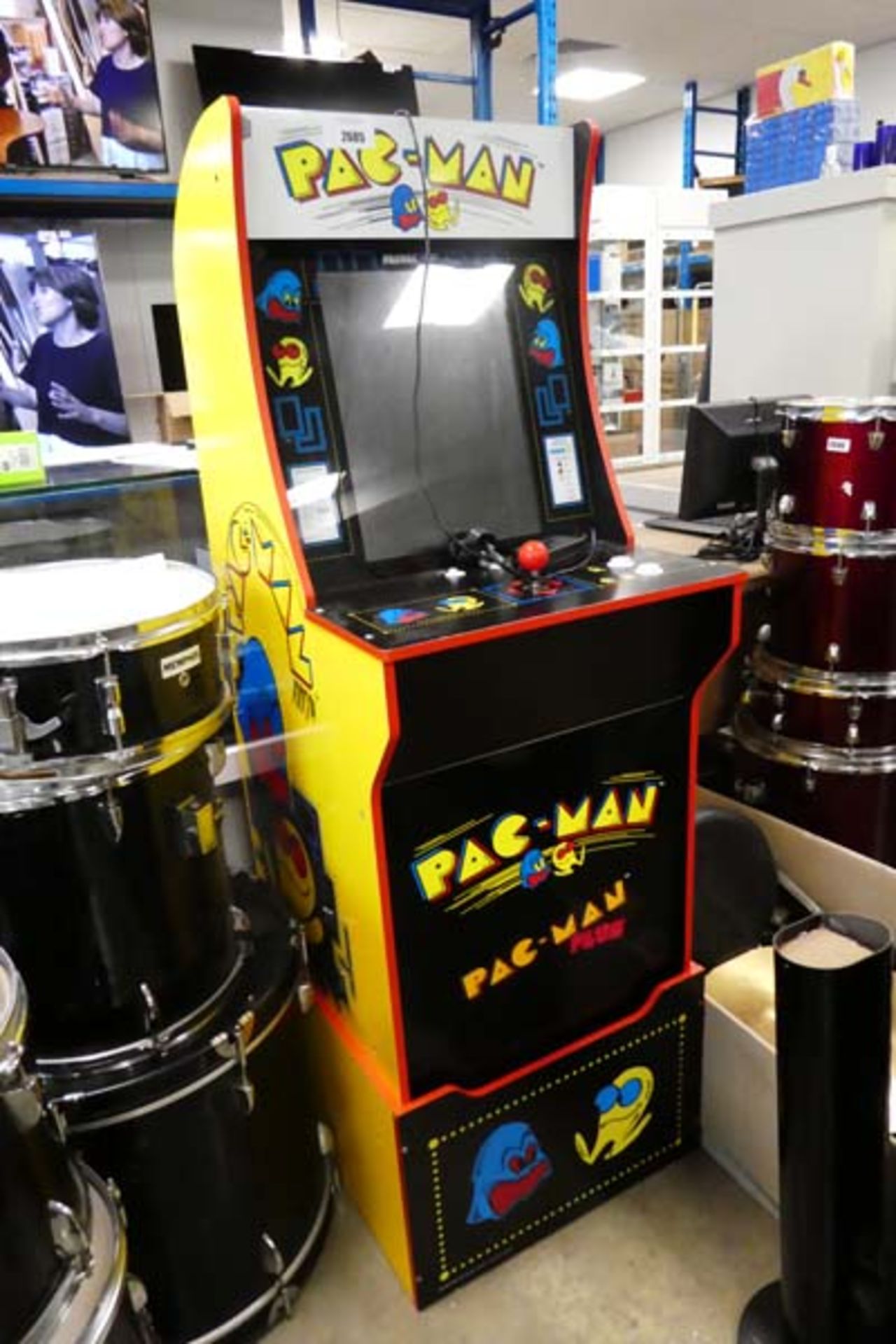 Pac Man arcade machine with pedestal and power supply Item is used, sound and joysticks work, screen