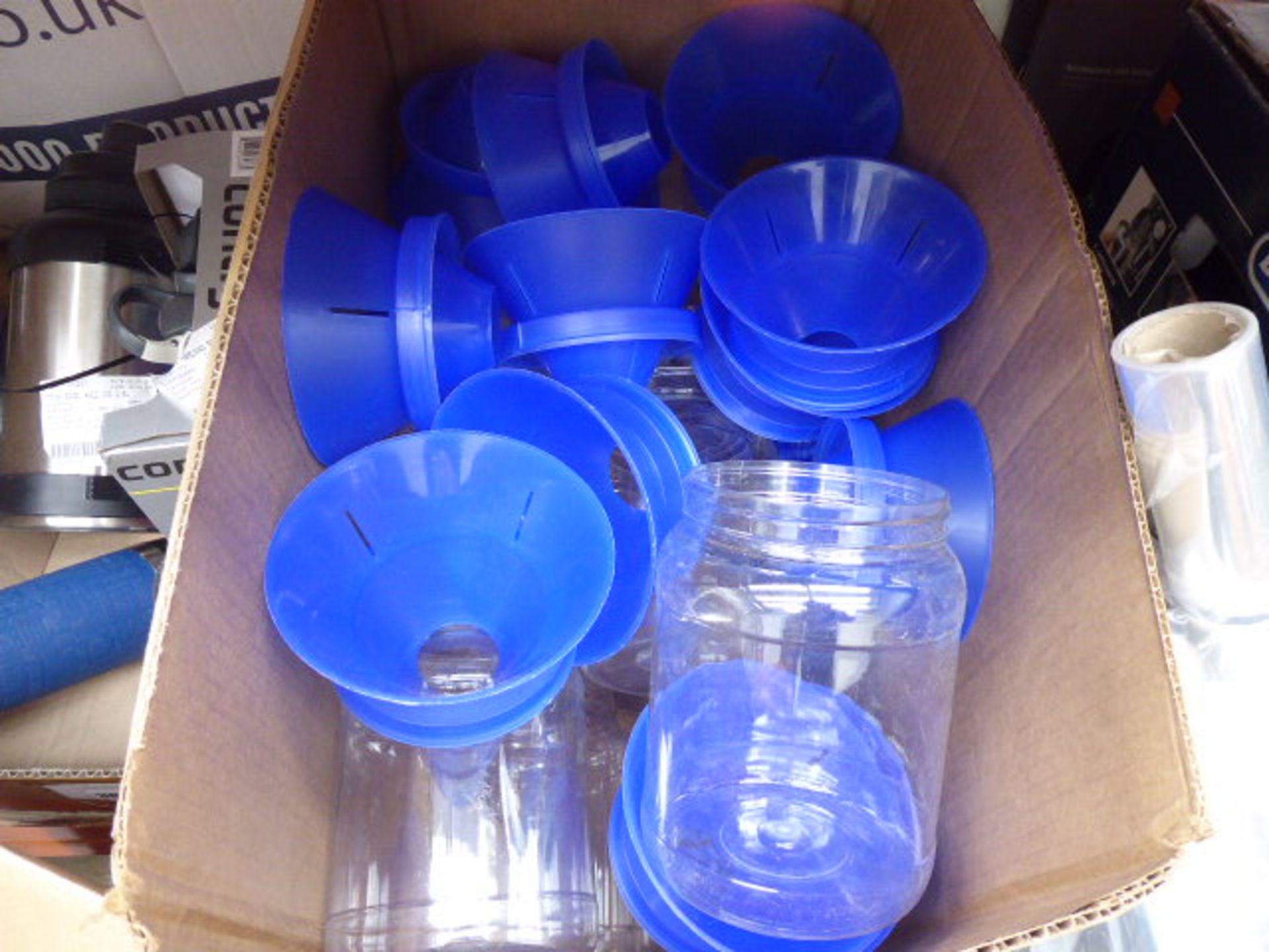 Box containing plastic jars with blue filtering lids
