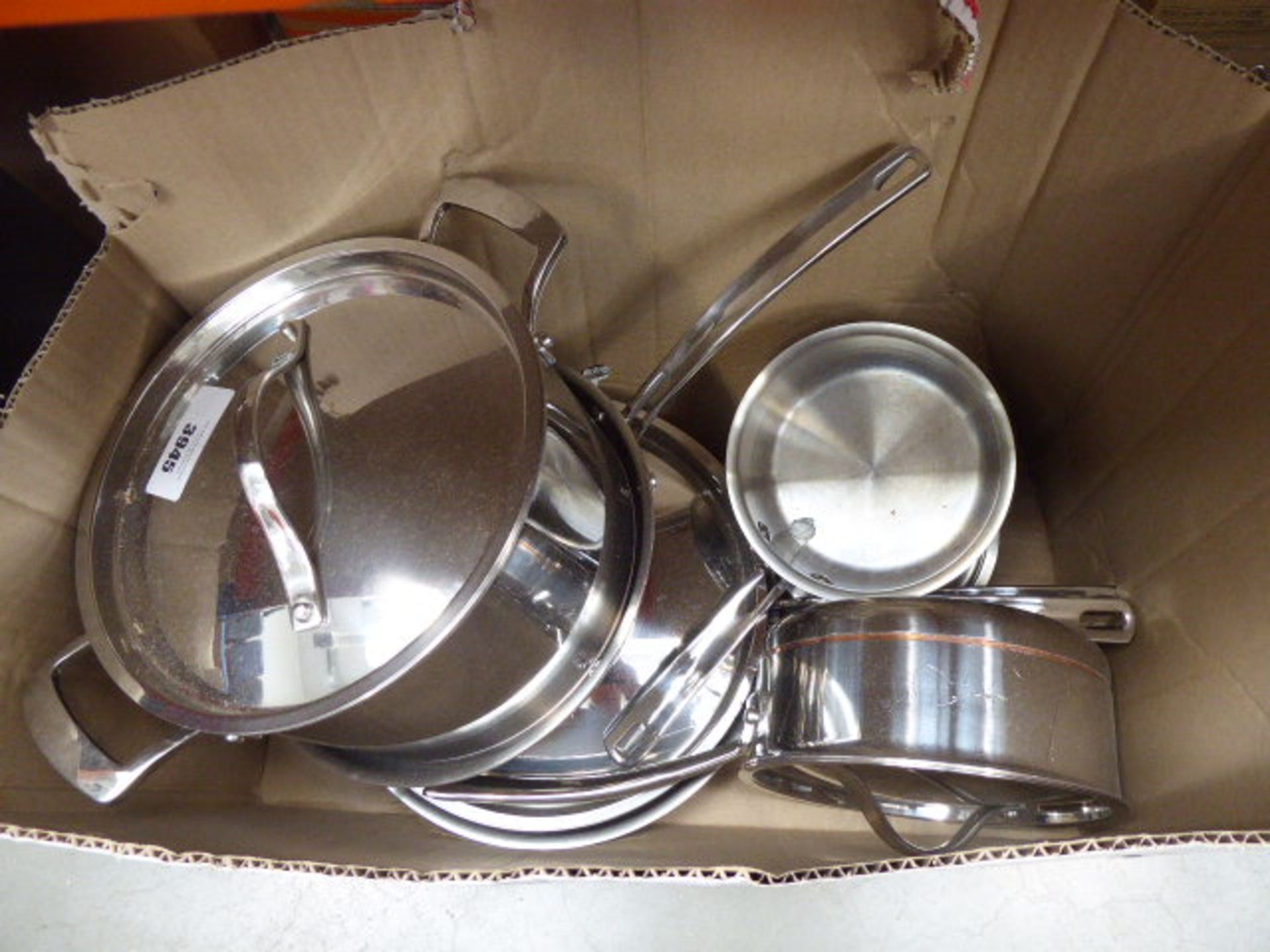 Box containing used Kirkland pots and pans