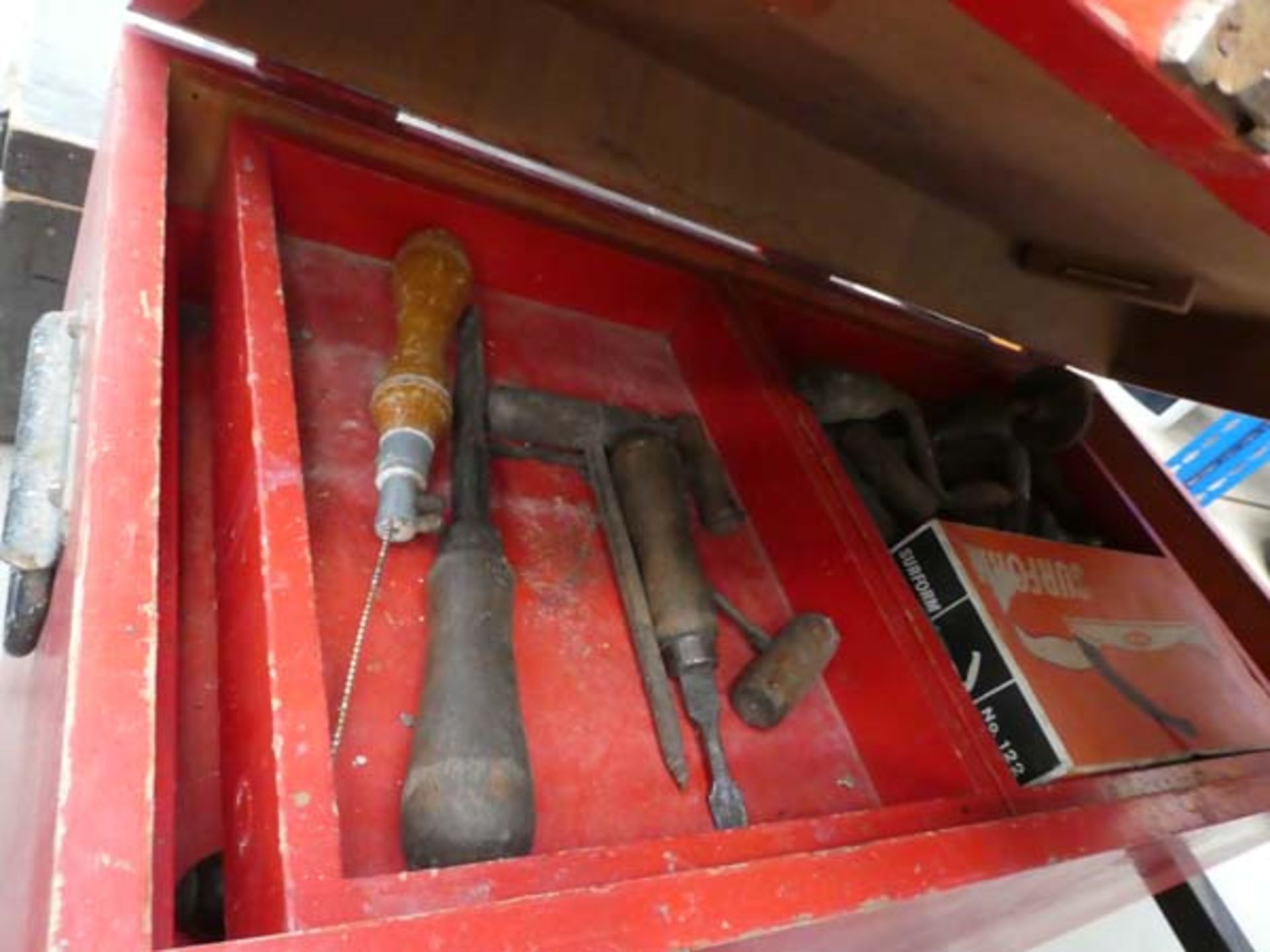 Large red carpenters tool box with hand drills, chisels, mini saws etc.