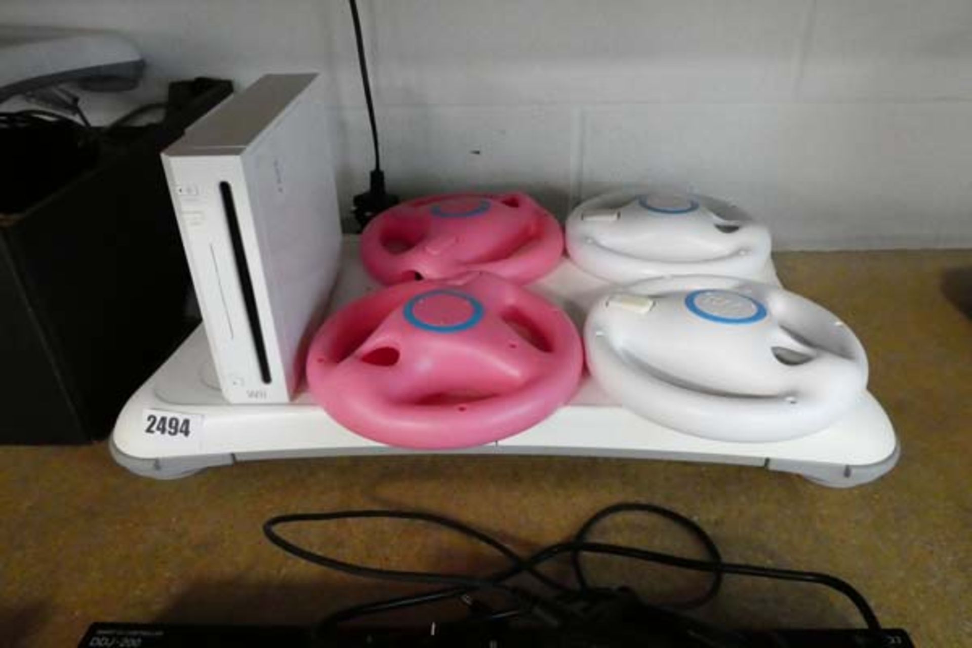 Nintendo Wii unit with balance board, steering wheel controller covers, no other accessories