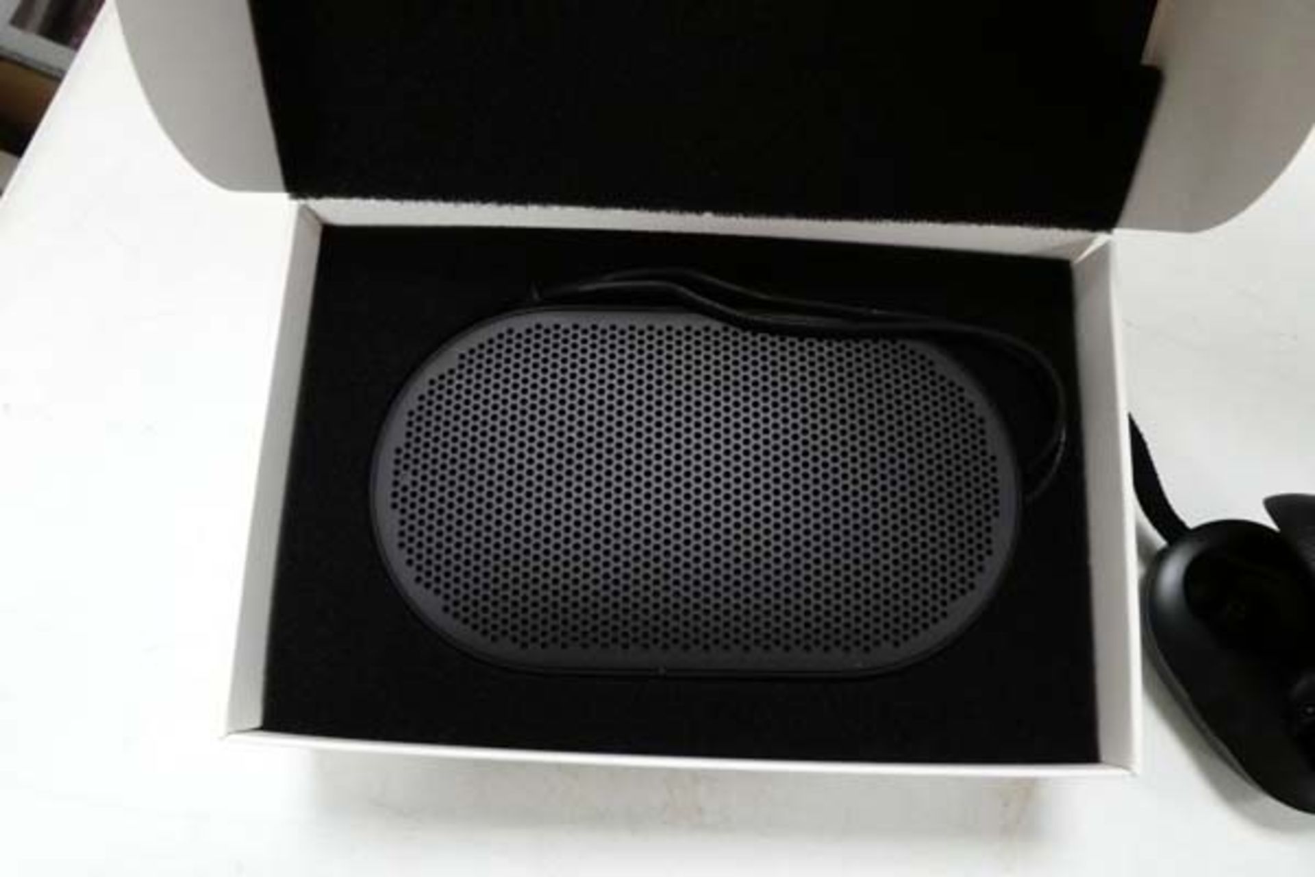 Bang & Olufsen P2 portable bluetooth speaker along with a Bang & Olufsen E8 wireless charging case - Image 2 of 4